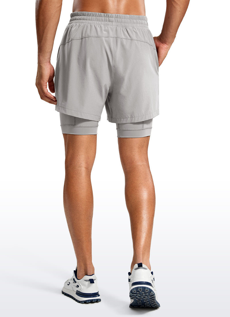 CRZ YOGA Men's Train Relaxed Fit Feathery-Fit 2 in 1 Shorts 5'' with Long Liner Dark Chrome @model_info:Jhony