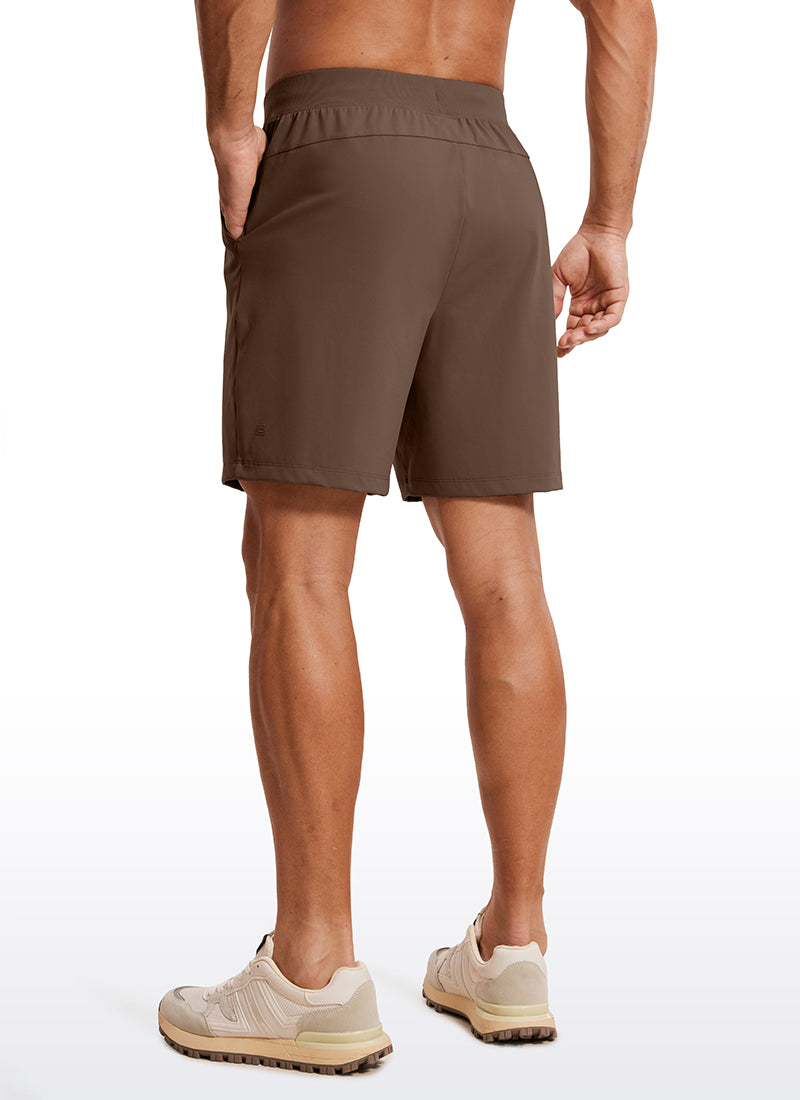 CRZ YOGA Men's Train Relaxed Fit On the Travel Linerless Shorts 7'' Dark Olive Brown @model_info:ALE