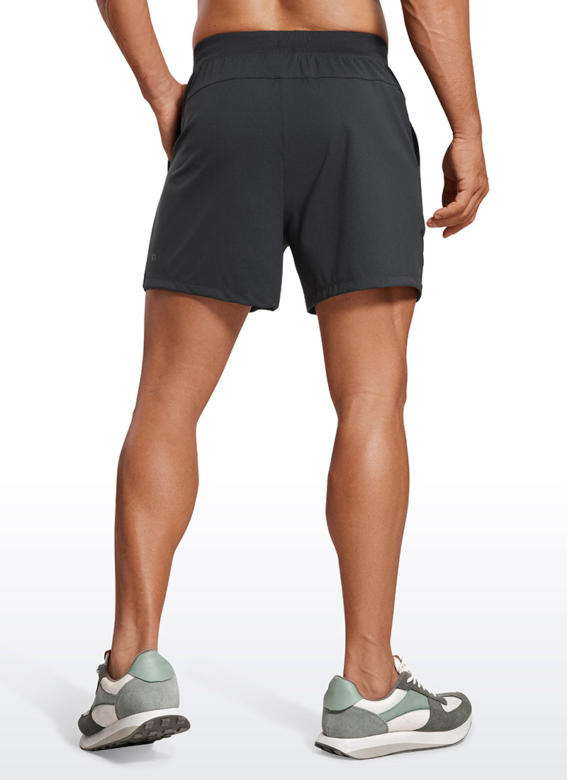 CRZ YOGA Men's Train Relaxed Fit On the Travel Linerless Shorts 5'' Ink Gray @model_info:Mazi