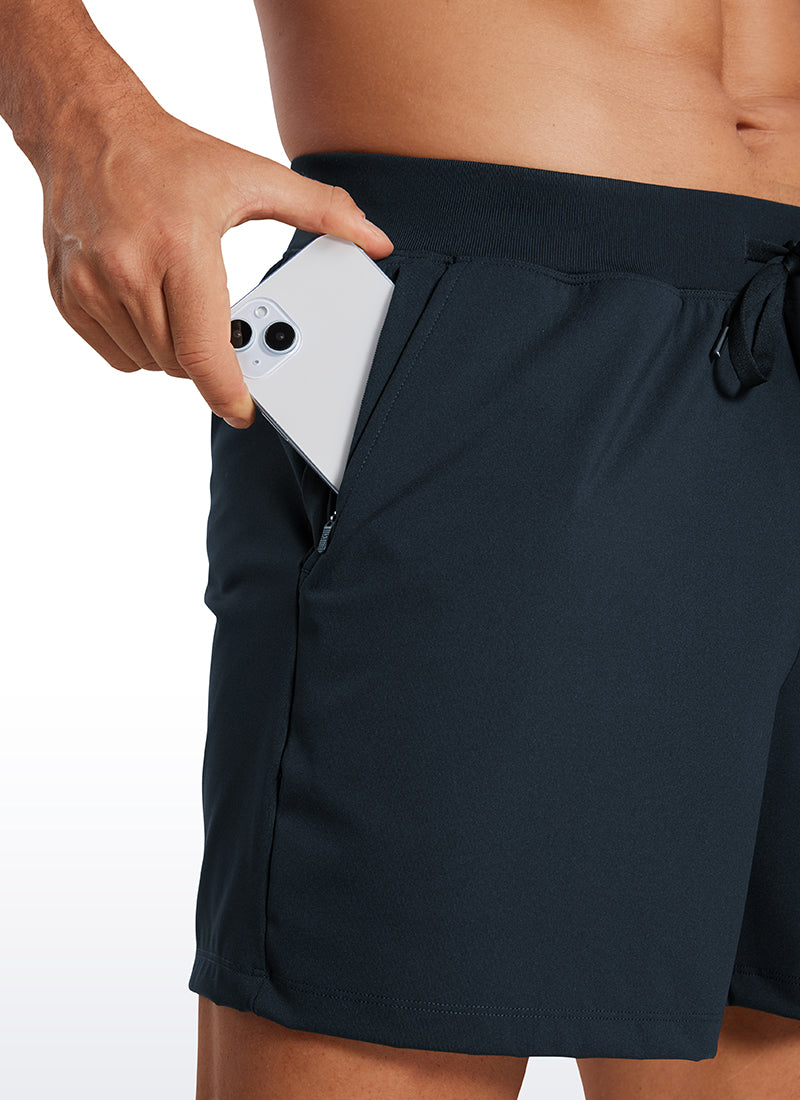 CRZ YOGA Men's Train Relaxed Fit On the Travel Linerless Shorts 5'' True Navy @model_info:Mazi