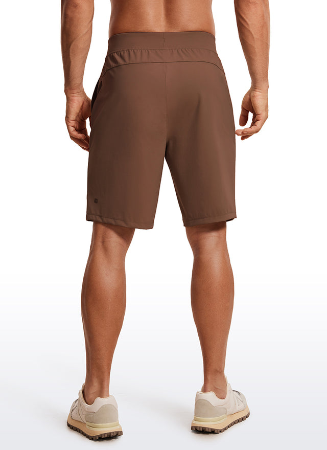 CRZ YOGA Men's Train Relaxed Fit On the Travel Linerless Shorts 9'' Dark Brown @model_info:ALE