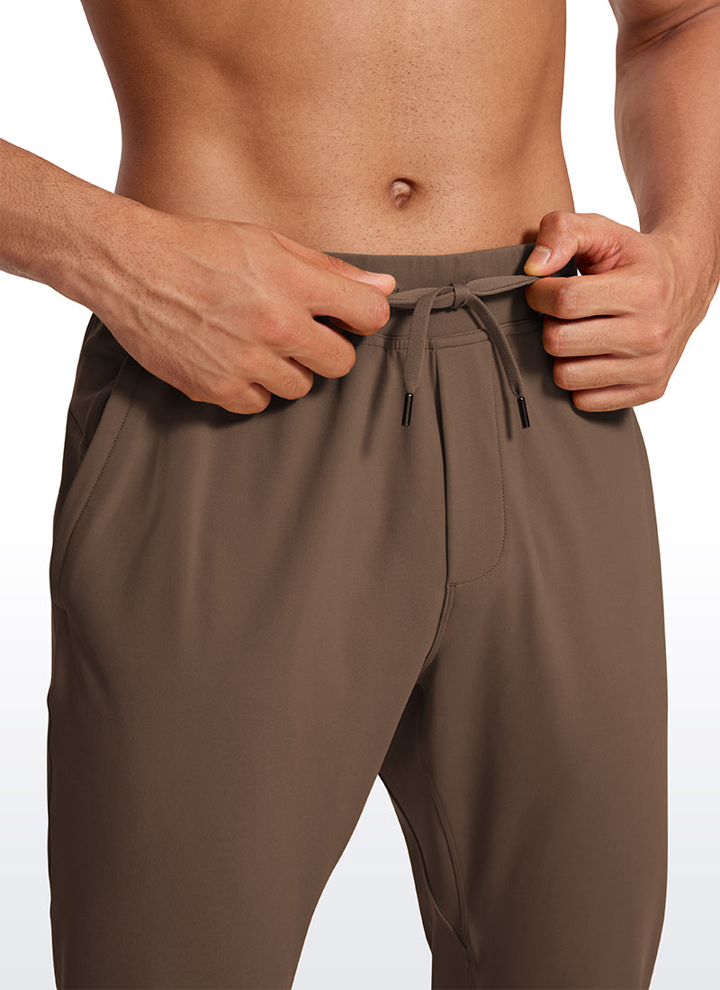 CRZ YOGA Men's Train Relaxed Fit On the Travel Pants 30'' Dark Olive Brown @model_info:Jhony