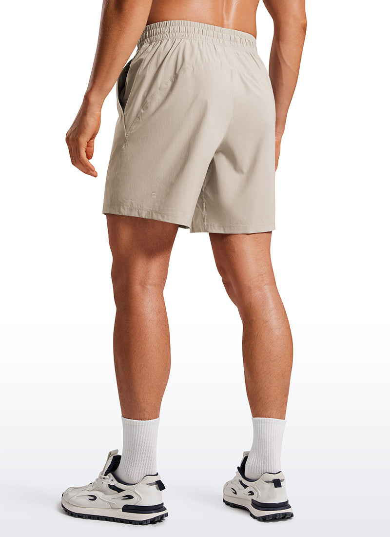 CRZ YOGA Men's Training Quick Dry Pocketed Linerless Shorts 7'' Mojave Tan
