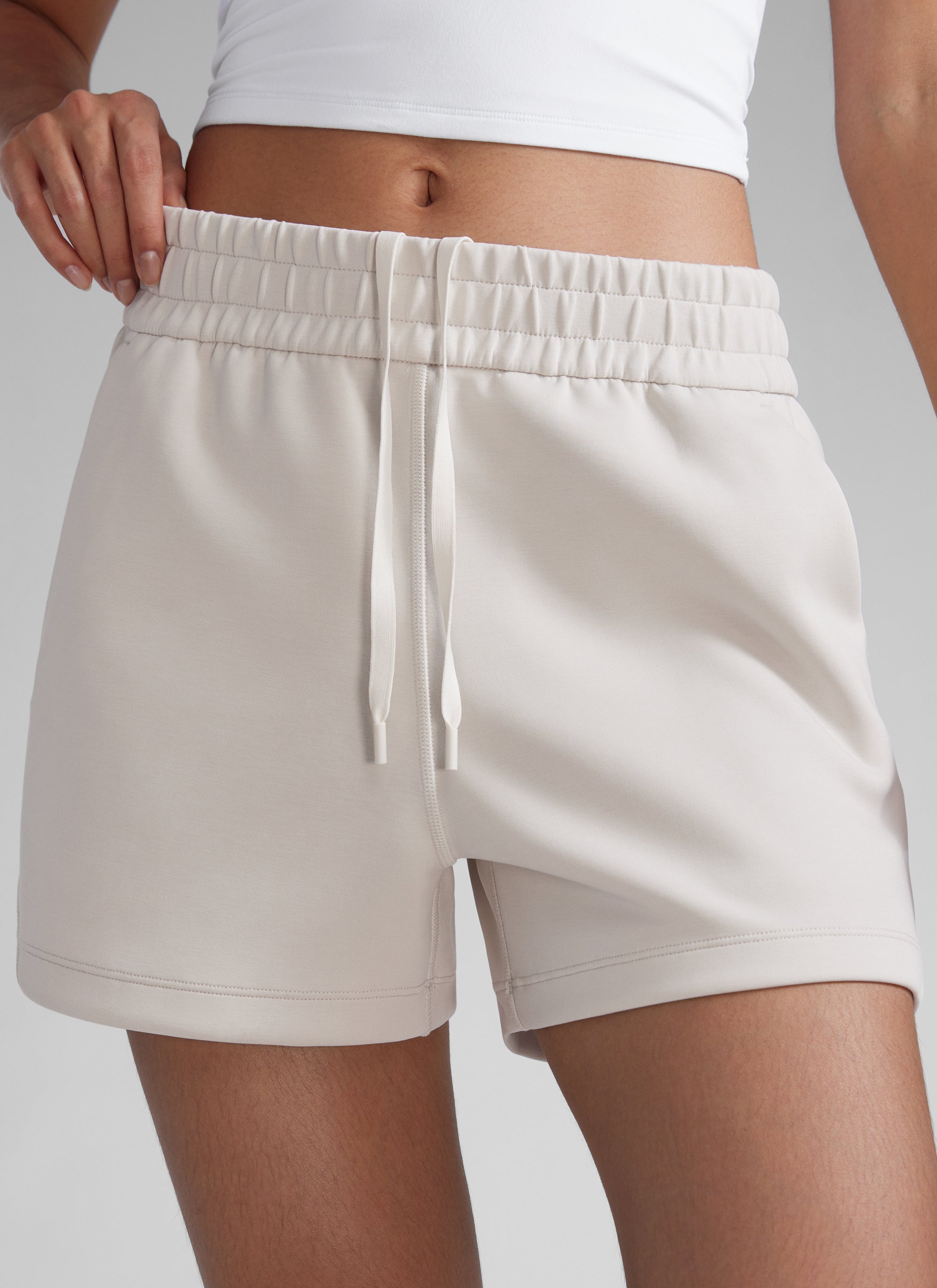 CRZYOGA Women SoftAura Sweat Shorts 4” with Pockets Drawstring Milky White @model_info:Paula