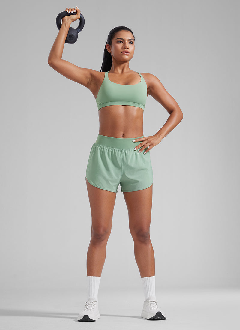 CRZ YOGA Women's Feathery-Fit Soft Mid Waisted Shorts 3” with Pockets Liner Green Palm Court @model_info:Amanda